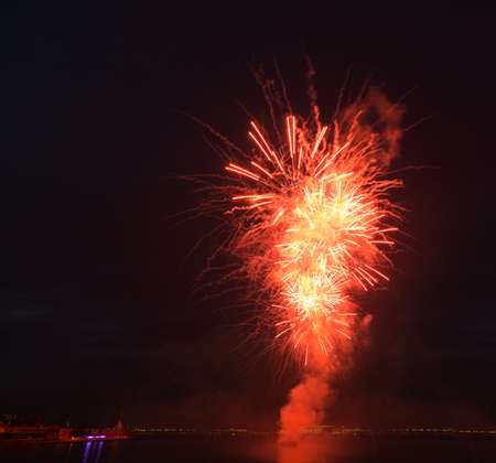 night city celebration holiday bright firework above river long exposure shootの写真素材
