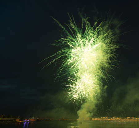 night city celebration holiday bright firework above river long exposure shootの写真素材