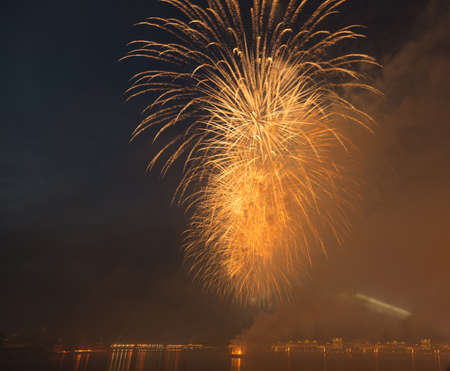 night city celebration holiday bright firework above river long exposure shootの写真素材