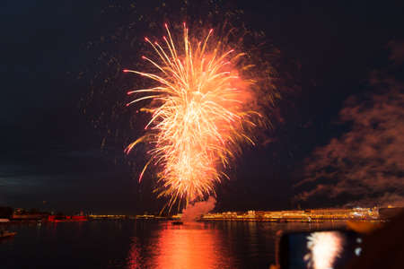 night city celebration holiday bright firework above river long exposure shootの写真素材