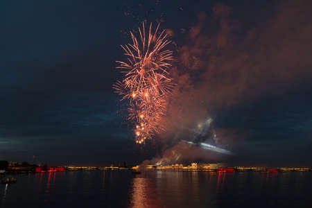 night city celebration holiday bright firework above river long exposure shootの写真素材