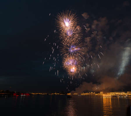 night city celebration holiday bright firework above river long exposure shootの写真素材