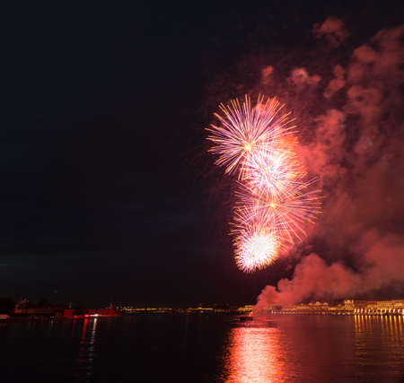 night city celebration holiday bright firework above river long exposure shootの写真素材