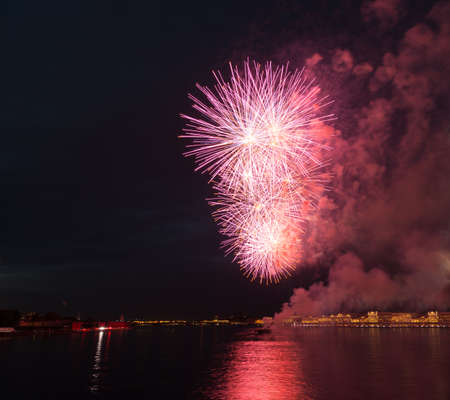 night city celebration holiday bright firework above river long exposure shootの写真素材