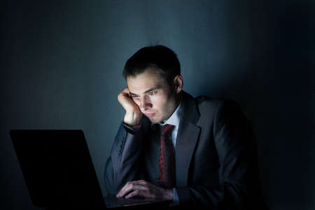 businessman working with computer at night
