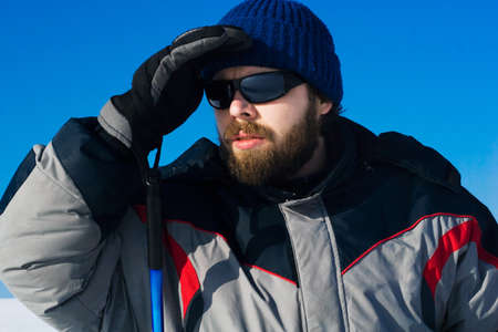 portrait of handsome skier in the snowy field