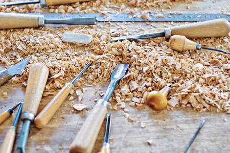 Tools for working wood lying among chipsの写真素材