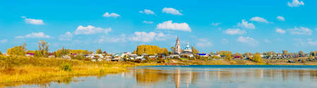 Panorama of Russian village Sredneivkino with a church in the autumn