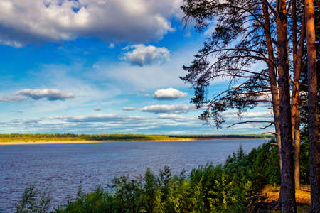 Waves on the surface of the river and cloudy skyの写真素材