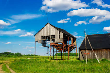 Old ruined abandoned grain elevator in the fieldの写真素材