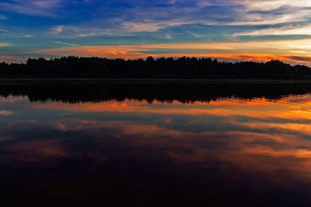 sunset in the clouds over the river