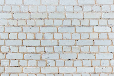 old cracked white brick wall in hoarfrost