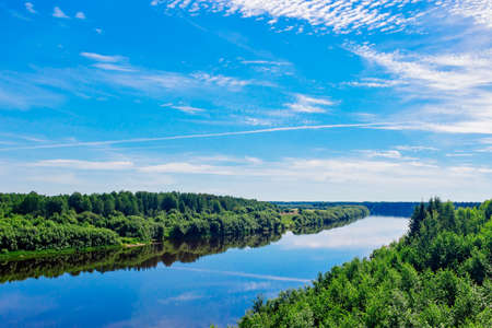 river with reflections of clouds on a summer day