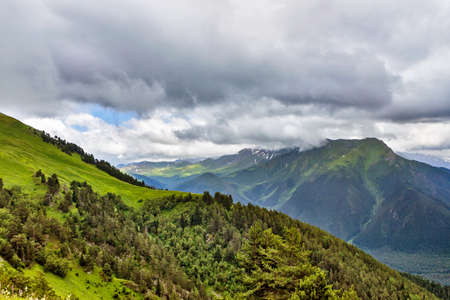 caucasian mountains and cloudy sky on a summer dayの写真素材
