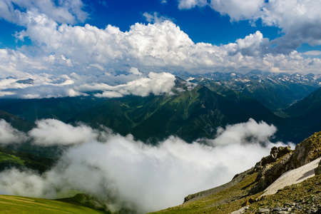 View of the Caucasian mountains and a cloudy sky from a height on a summer day