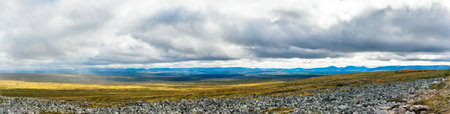 View of the rocky tundra and taiga in the distance in the Subpolar Urals on a rainy dayの写真素材