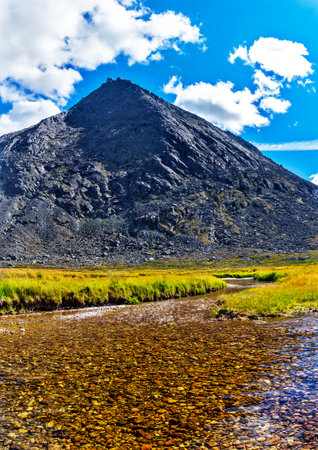 Stream and mountain peak in the Subpolar Urals on a summer dayの写真素材