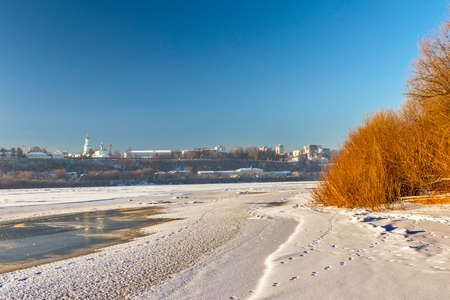 panorama of the frozen river and city on a cold winter dayの写真素材