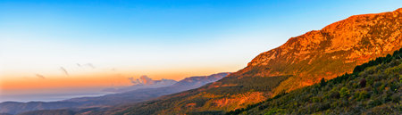 View from the mountains at sunrise over the hills and the sea in Crimea on an autumn morning