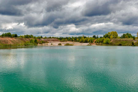 lake in the limestone quarry on a cloudy gloomy summer dayの写真素材