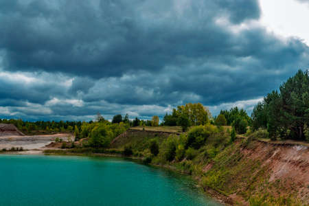 lake in the limestone quarry on a cloudy gloomy summer dayの写真素材