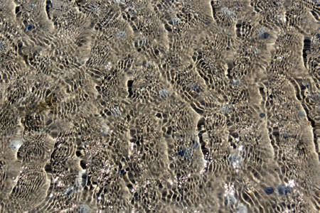 Rippling wavelets in estuary as tide recedesの写真素材