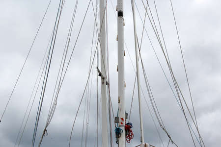 Yacht sail masts on cloudy day