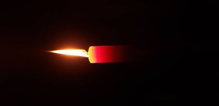 flame red candle burns on a dark background, fireの写真素材