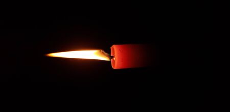 flame red candle burns on a dark background, fireの写真素材
