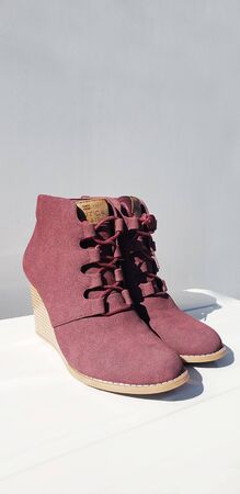 Female violet suede boots on grey background, isolated product, top view.の写真素材