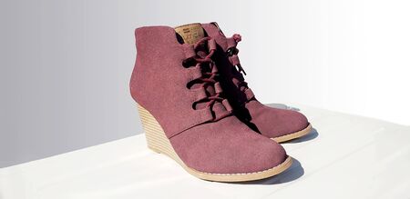 Female violet suede boots on grey background, isolated product, top view.の写真素材