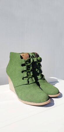 Female green suede boots on white background, isolated productの写真素材