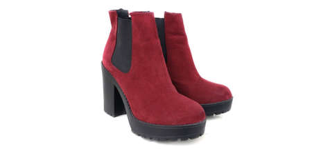 Female dark red suede boots on white background, isolated product, top view. heeled shoesのeditorial素材