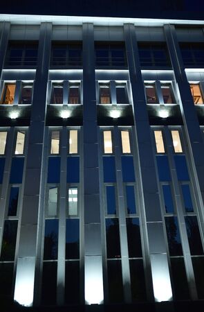 backlit administrative building at night, photo of searchlights, building lighting, night illuminationの写真素材