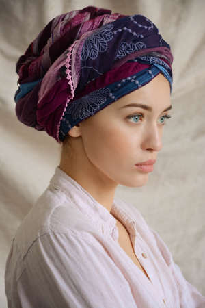 Portrait of a beautiful sexy brunette girl with nude makeup and oriental turbanのeditorial素材