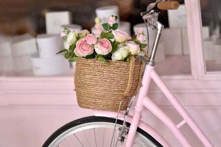 Bicycle with lilac, roses and tulips background isolated on pinkの写真素材