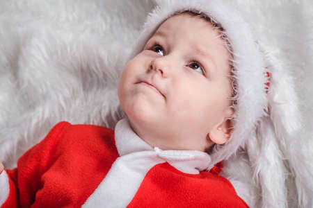 portrait of a little boy lying on his back