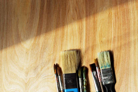 Brushes for drawing on a wooden backgroundの写真素材