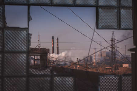 abandoned place with industrial background. Industrial zone view on pipes with smokeの写真素材