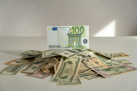 pile of dollars and euro. One hundred euro