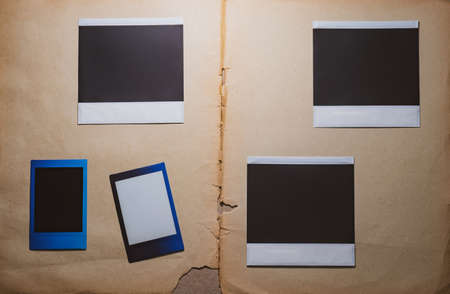 Blank photo frames on book background as template. Top View of photo frame, memory of a trip or adventure. Photo cardsの写真素材