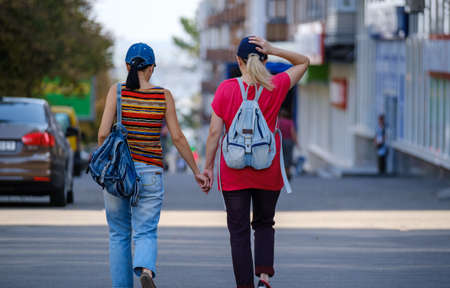 couple women walking on the street. Happy girlfriends