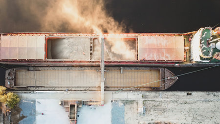 Top view from drone of a large ship loading grain for export. Water transportの写真素材