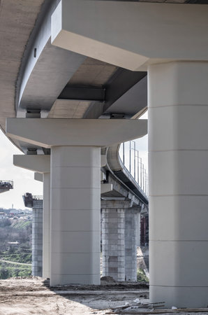 Pillar of bridge. Underside of an elevated roads. Gray pillars support the weight of the structure....