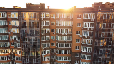 Sunlight streaming into tall building through windows, illuminating urban designの写真素材