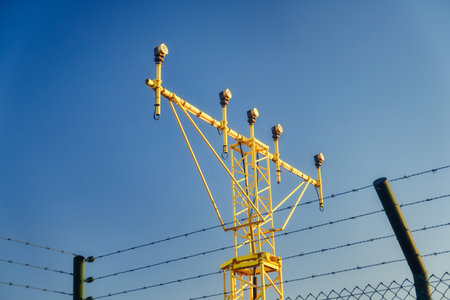 yellow metal structure with multiple arms and devices mounted at the top, an instrument landing system ILS located at an airport. The ILS is a radio navigation systemの写真素材