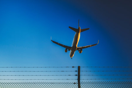 This image shows an airplane in the middle of landing or taking off, seen from a perspective where...