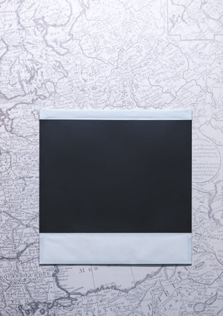 Top View of photo frame on map, Memory of a trip or adventure. Photo card with space for your logo...