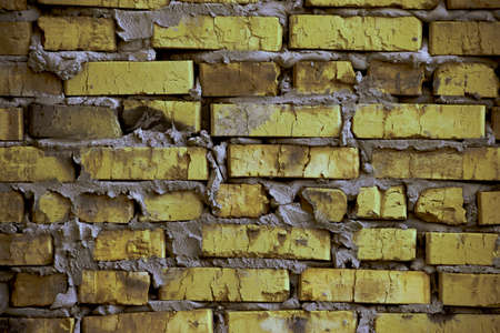 brickwork of the cracked and weathered stained rough brick. Art edition. Rustic yellow-green stylized brick.の写真素材