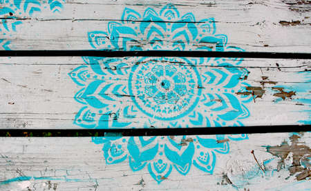 Chipped and rustic flower on picnic tableの写真素材